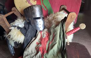 Knight's armour and clothes on display table